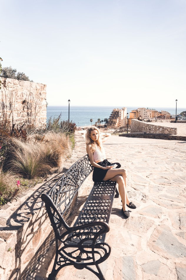 Girl sitting on bench wearing Hanna Algarve top.